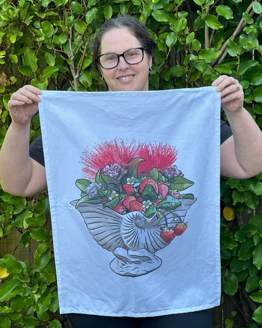 NZ artist Anna Mollekin holding her Strawberry Jam Crown Lynn Nautilus tea towel in the garden
